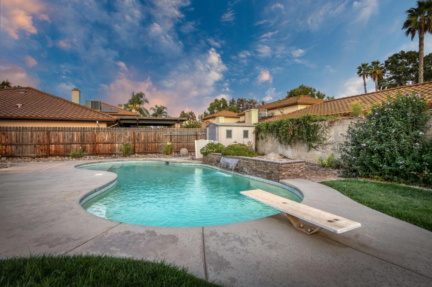 3040 Boulder Avenue Madera, CA 93637 - Photo 8 of 50 a view of a swimming pool with a yard