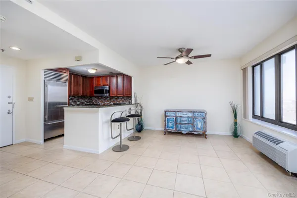 a living room with furniture and a kitchen