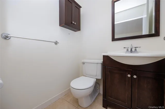 a bathroom with a sink a toilet and mirror