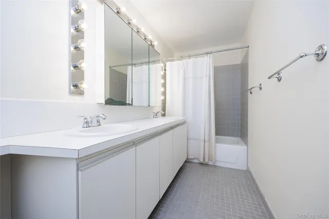 a bathroom with a double vanity sink and mirror
