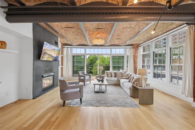 a living room with furniture and a fireplace