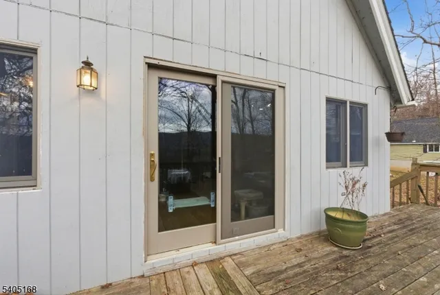 a room with wooden floor and a potted plant