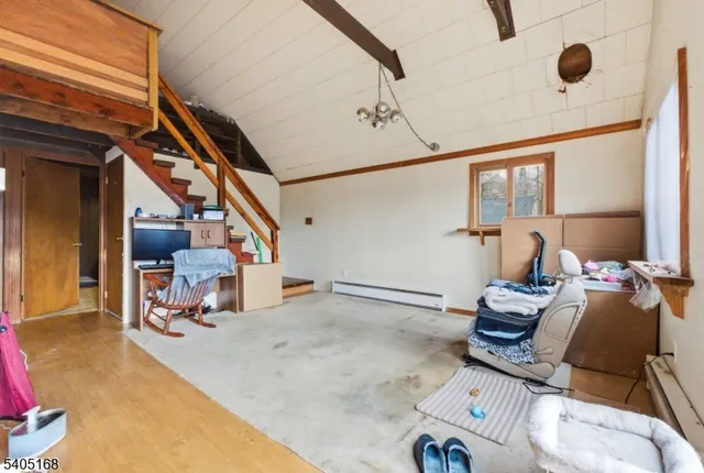 a living room with furniture a window and gym equipment