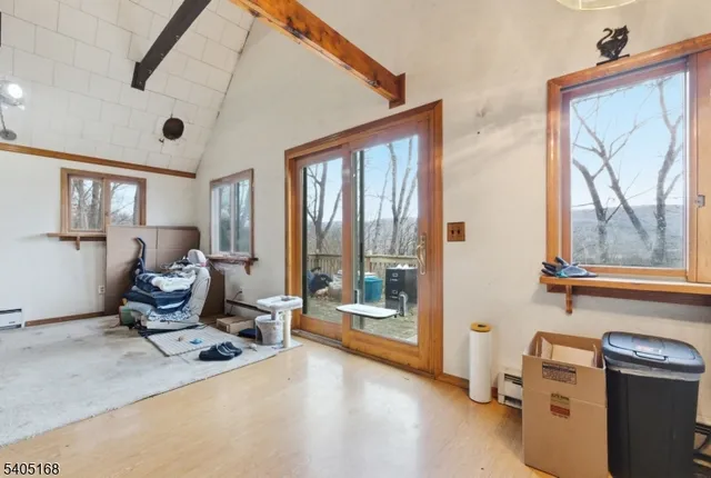 a view of a big room with furniture and a large window