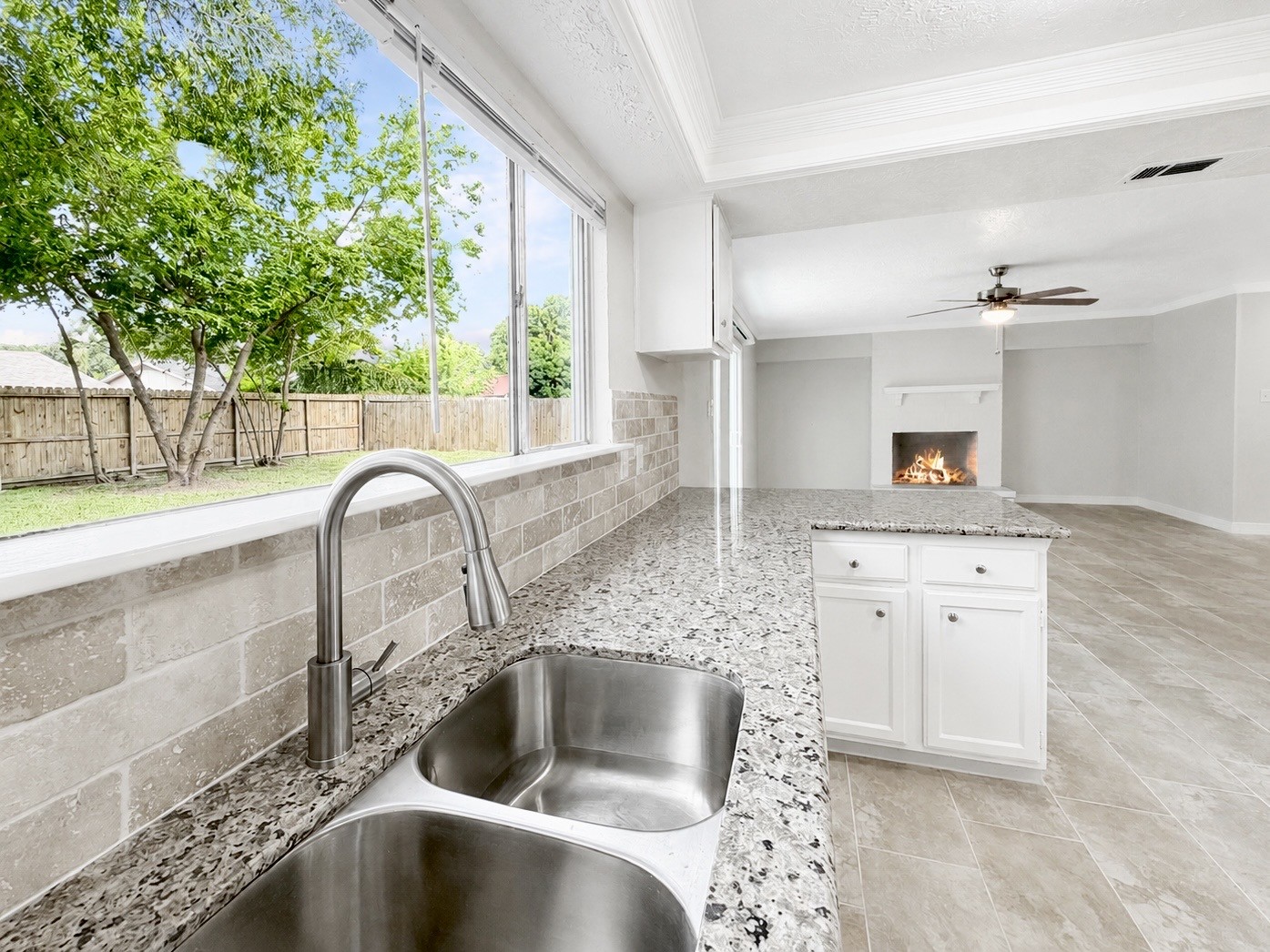 8407 Riverside Walk Lane Houston, TX 77064 - Photo 9 of 33 Kitchen overlooks the spacious backyard and opens seamlessly to the family room, making everyday living and entertaining effortless. Granite countertops, white cabinetry, new stainless steel appliances, and abundant natural light complete the space.
