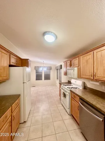 a kitchen with a stove a sink and a refrigerator