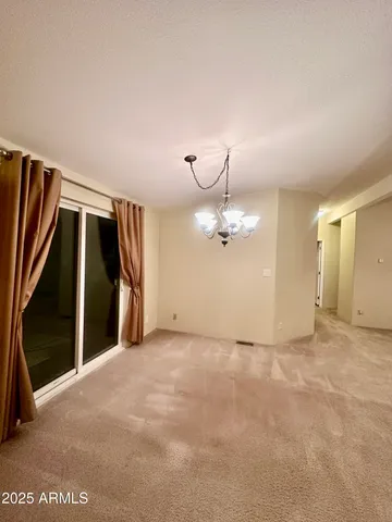 a view of an empty room with a mirror