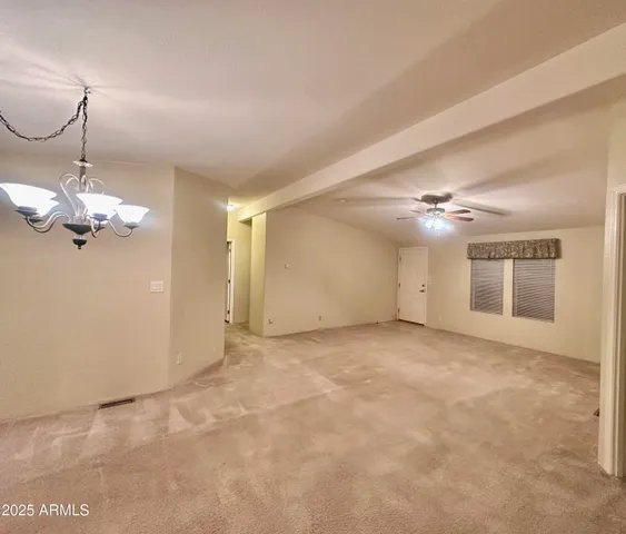 a view of a room with windows and ceiling fan