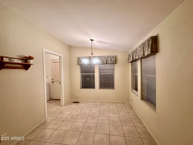 a view of a hallway with wooden floor and a window