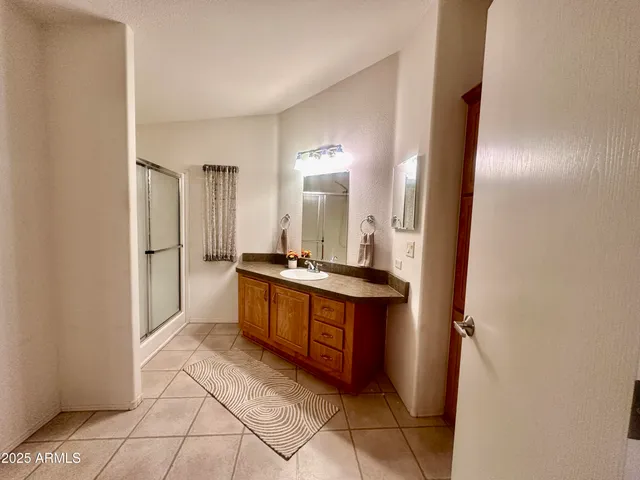 a spacious bathroom with a double vanity sink and a mirror