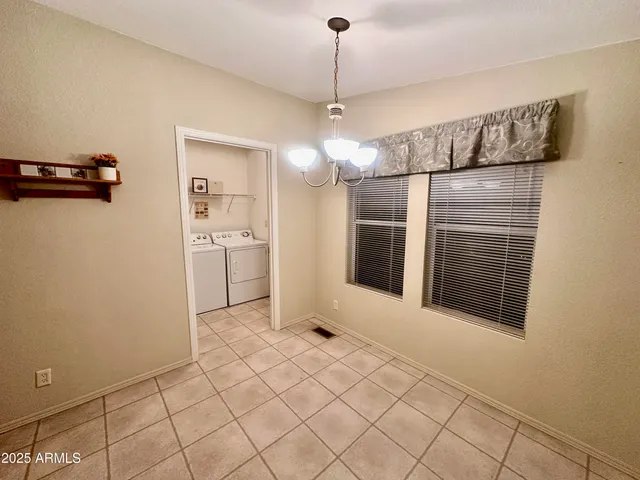 a view of a kitchen with refrigerator and window
