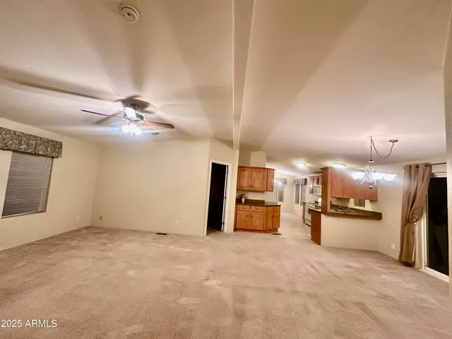a view of a kitchen with a sink and a refrigerator