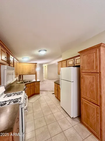 a kitchen with stainless steel appliances a refrigerator and a stove top oven