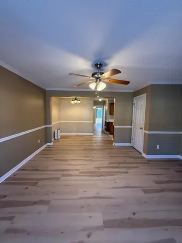 a view of a livingroom with a hall and wooden floor