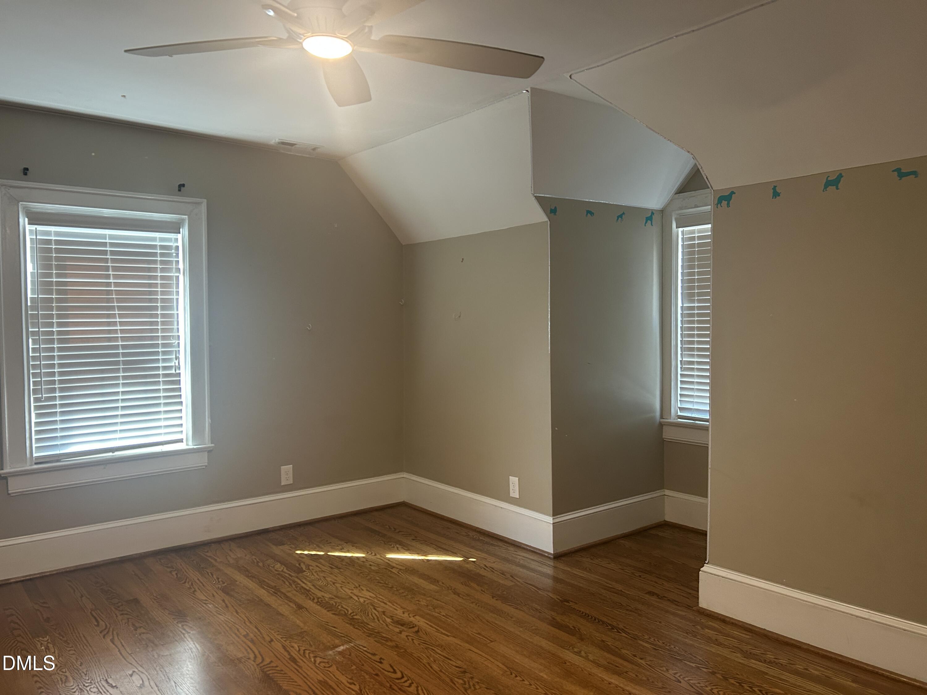 405 Sunset Avenue Clinton, NC 28328 - Photo 25 of 47 a view of an empty room with wooden floor and a window