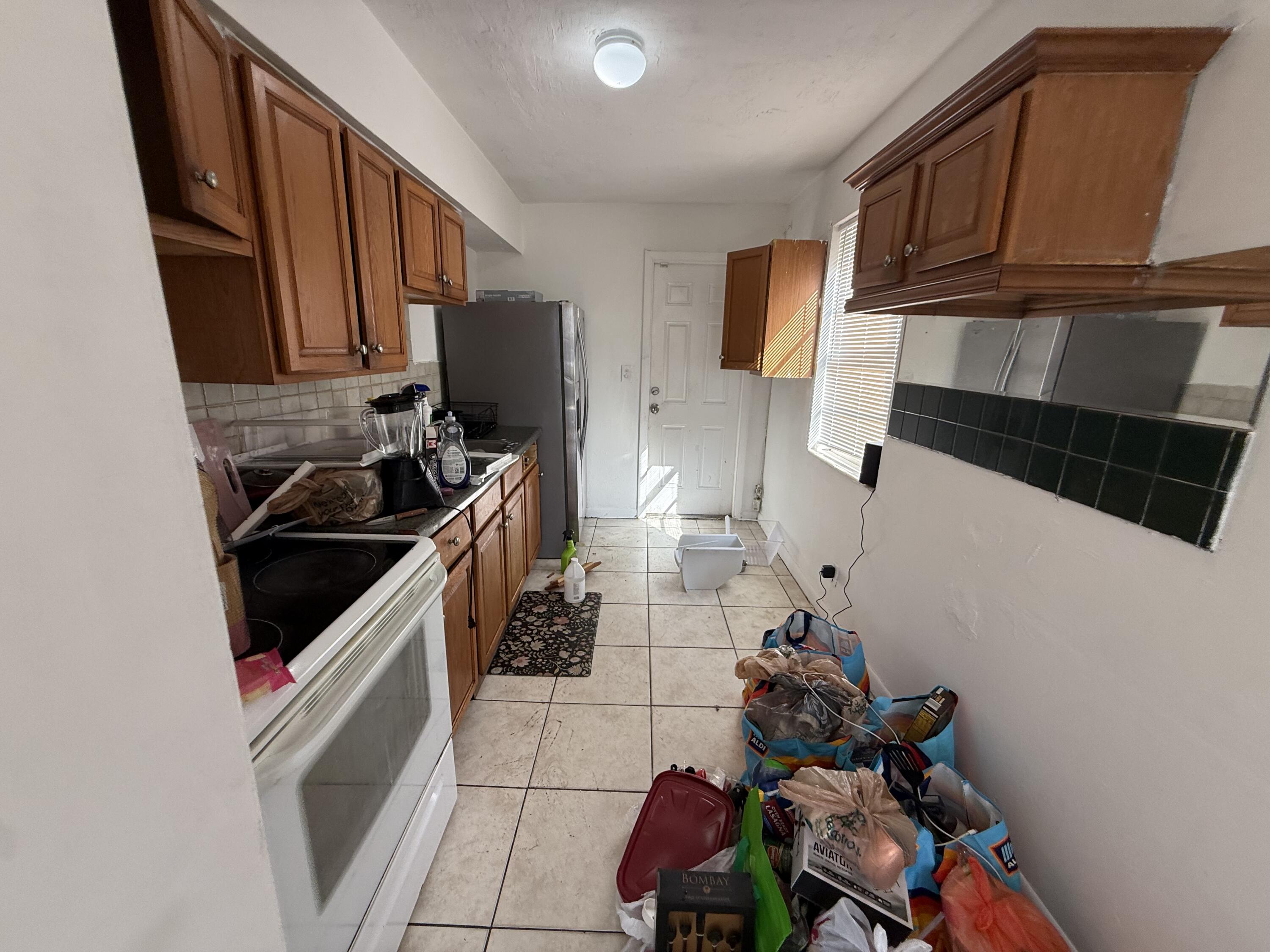 4800 Pembroke Road West Park, FL 33021 - Photo 10 of 10 a kitchen with sink refrigerator and cabinets