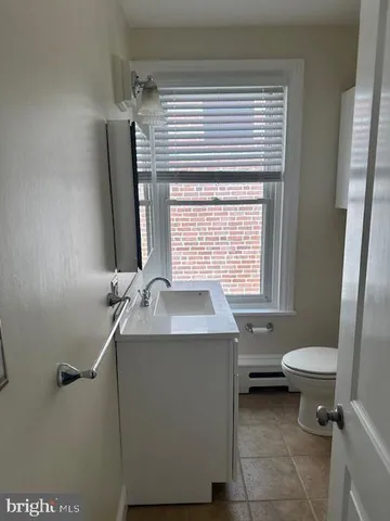 a bathroom with a sink toilet and a mirror