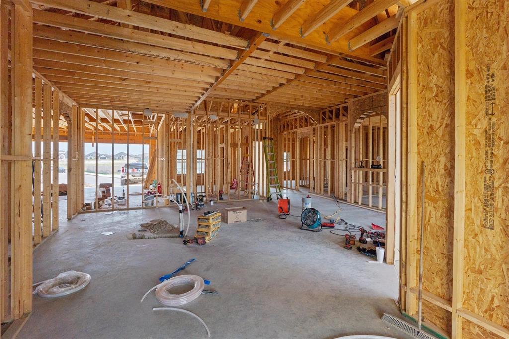 1405 Red Rock Road Hewitt, TX 76643 - Photo 17 of 25 New construction framing with wood studs, concrete slab foundation, and open ceiling joists
