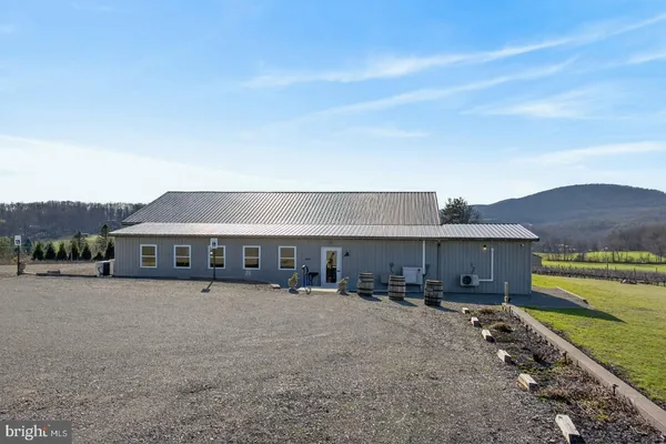 a view of a house with a yard and sitting area