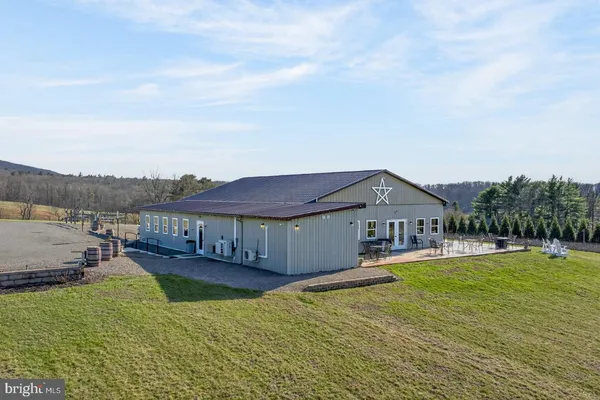 a view of a house with swimming pool and a yard