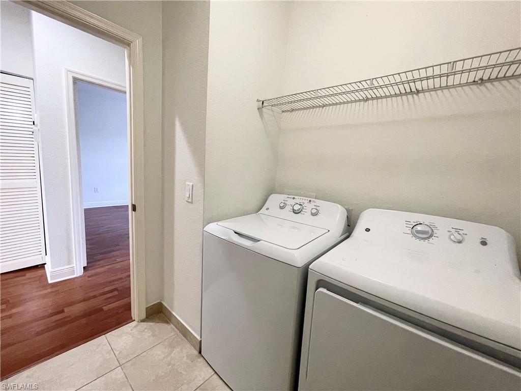 7051 Ambrosia Lane, Unit 3506 Naples, FL 34119 - Photo 13 of 23 a utility room with dryer and washer