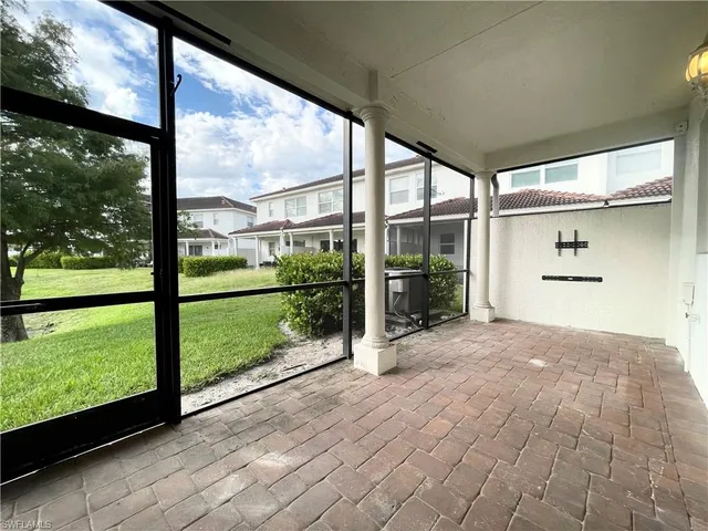 a view of porch with a floor to ceiling window next to a yard