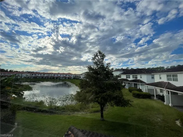 a view of a lake with houses in the back
