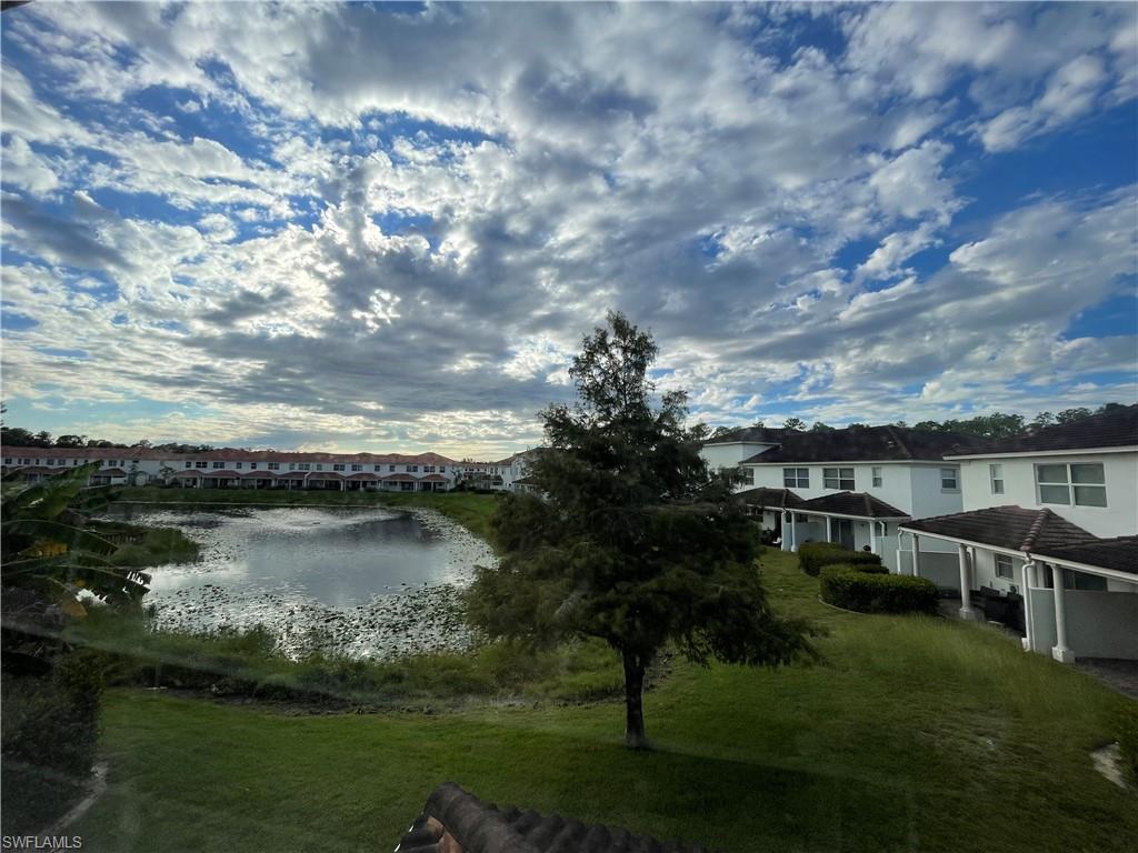 7051 Ambrosia Lane, Unit 3506 Naples, FL 34119 - Photo 19 of 23 a view of a lake with houses in the back