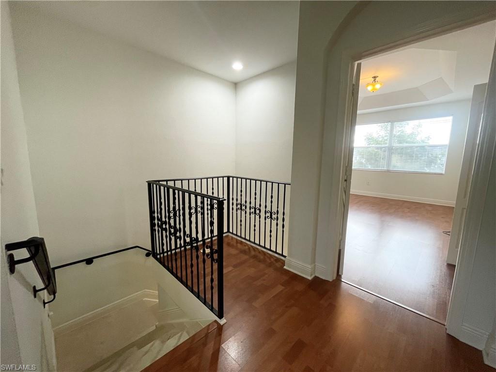 7051 Ambrosia Lane, Unit 3506 Naples, FL 34119 - Photo 20 of 23 a view of a hallway with wooden floor and a bathroom
