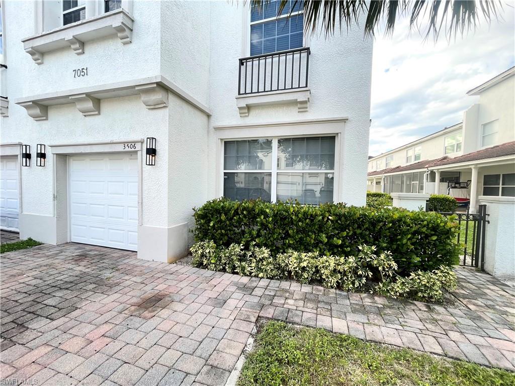 7051 Ambrosia Lane, Unit 3506 Naples, FL 34119 - Photo 5 of 23 a front view of a house with a yard