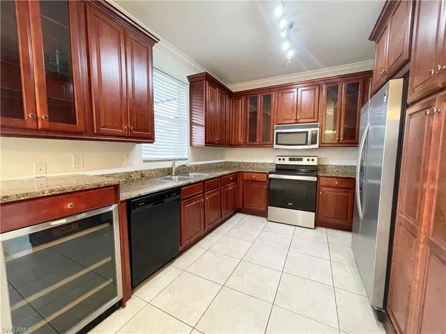 a kitchen with stainless steel appliances granite countertop a stove a sink dishwasher and a refrigerator