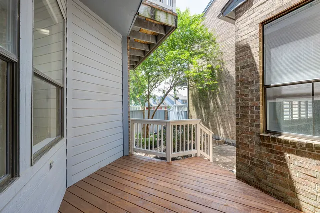 a view of a wooden deck and a backyard