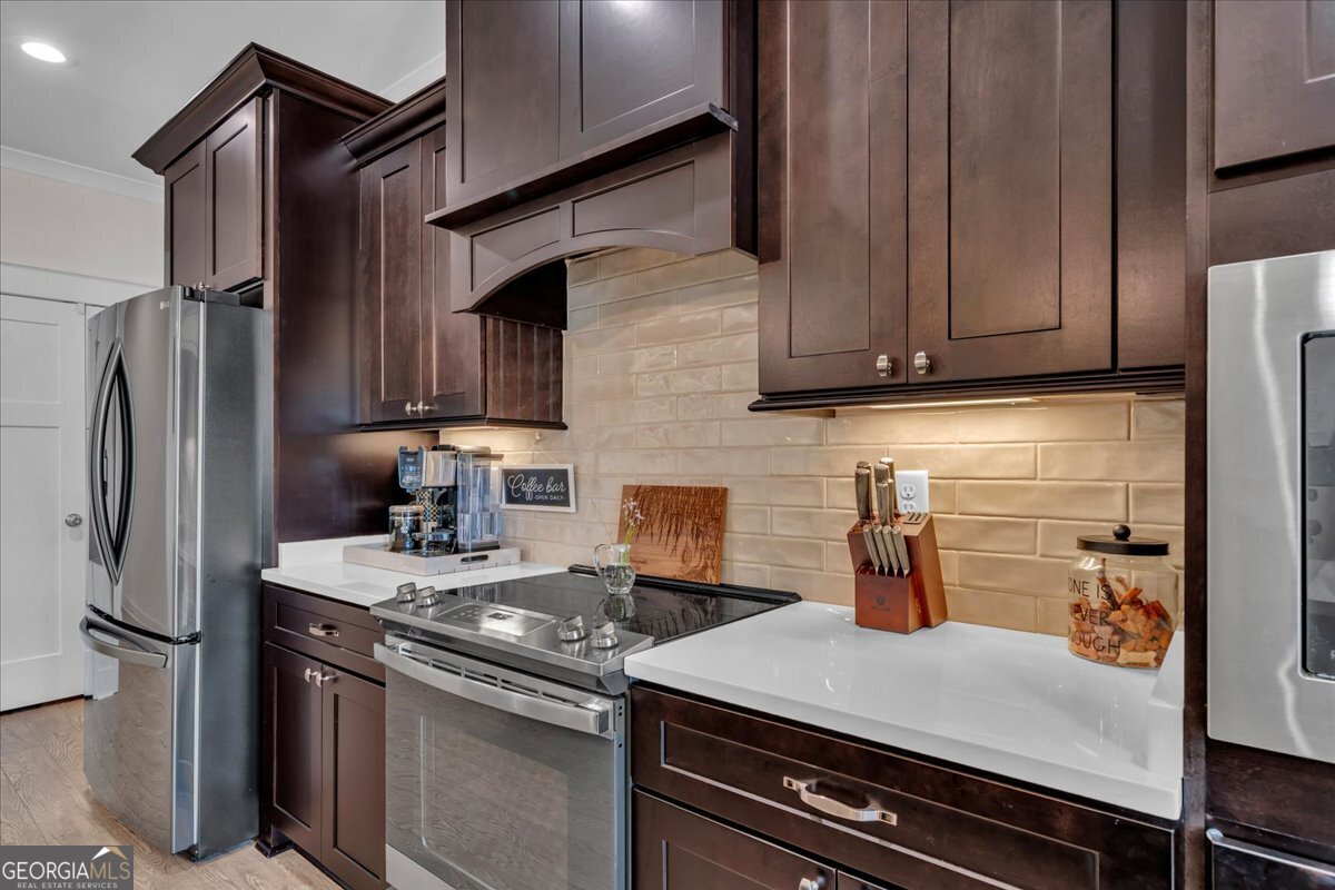 424 Rustic Live Oak Trail Bonaire, GA 31005 - Photo 16 of 51 a kitchen with a refrigerator and a stove top oven
