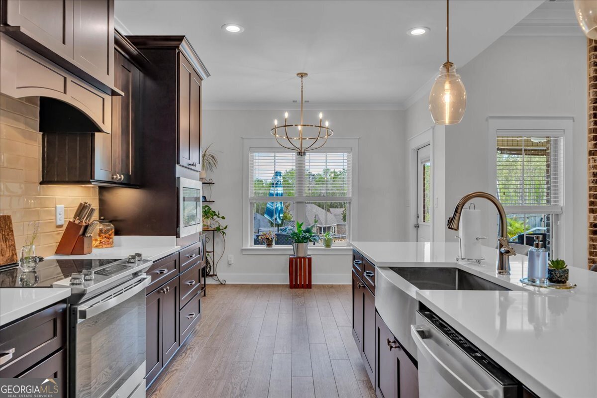 424 Rustic Live Oak Trail Bonaire, GA 31005 - Photo 17 of 51 a kitchen with a stove a sink and a refrigerator