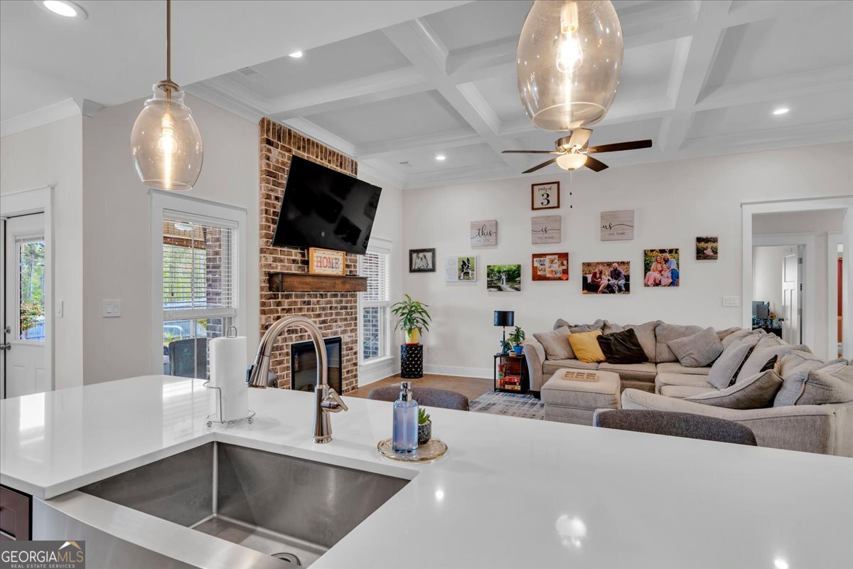 424 Rustic Live Oak Trail Bonaire, GA 31005 - Photo 18 of 51 a living room with fireplace furniture and a flat screen tv