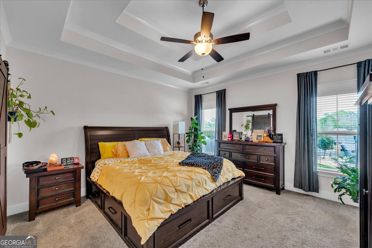 424 Rustic Live Oak Trail Bonaire, GA 31005 - Photo 19 of 51 a bed room with a bed and a ceiling fan