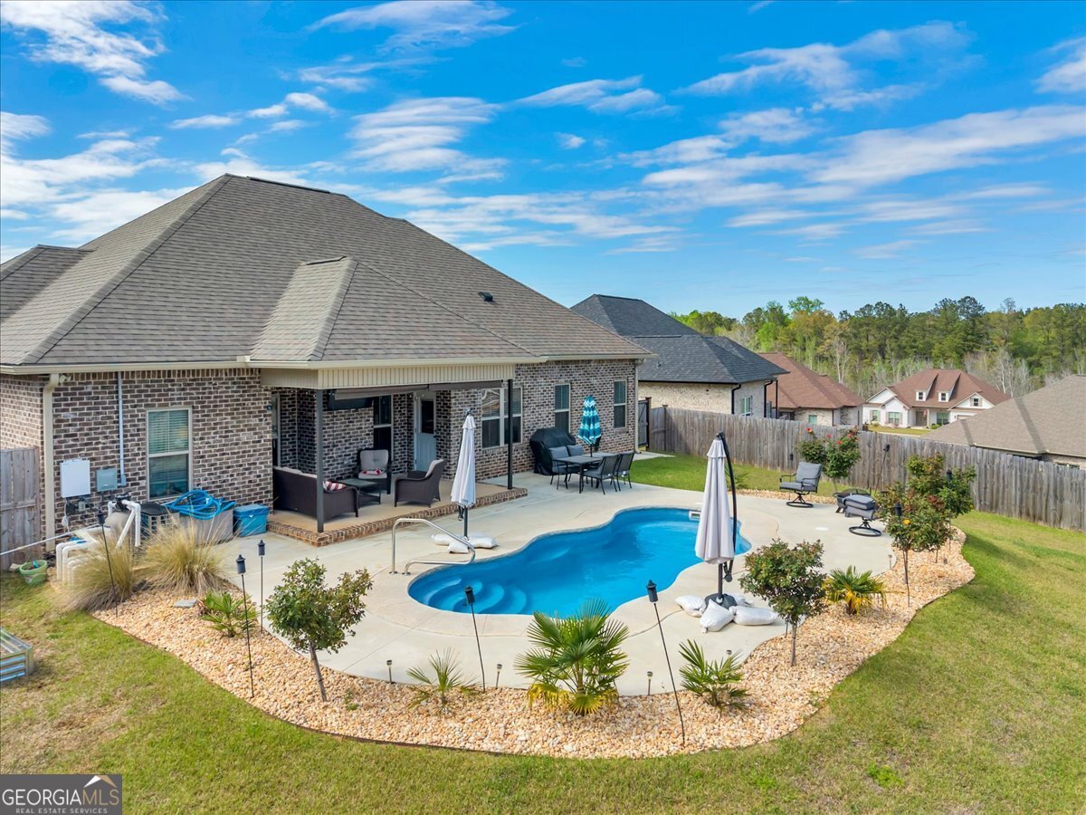 424 Rustic Live Oak Trail Bonaire, GA 31005 - Photo 2 of 51 a view of a house with swimming pool and sitting area