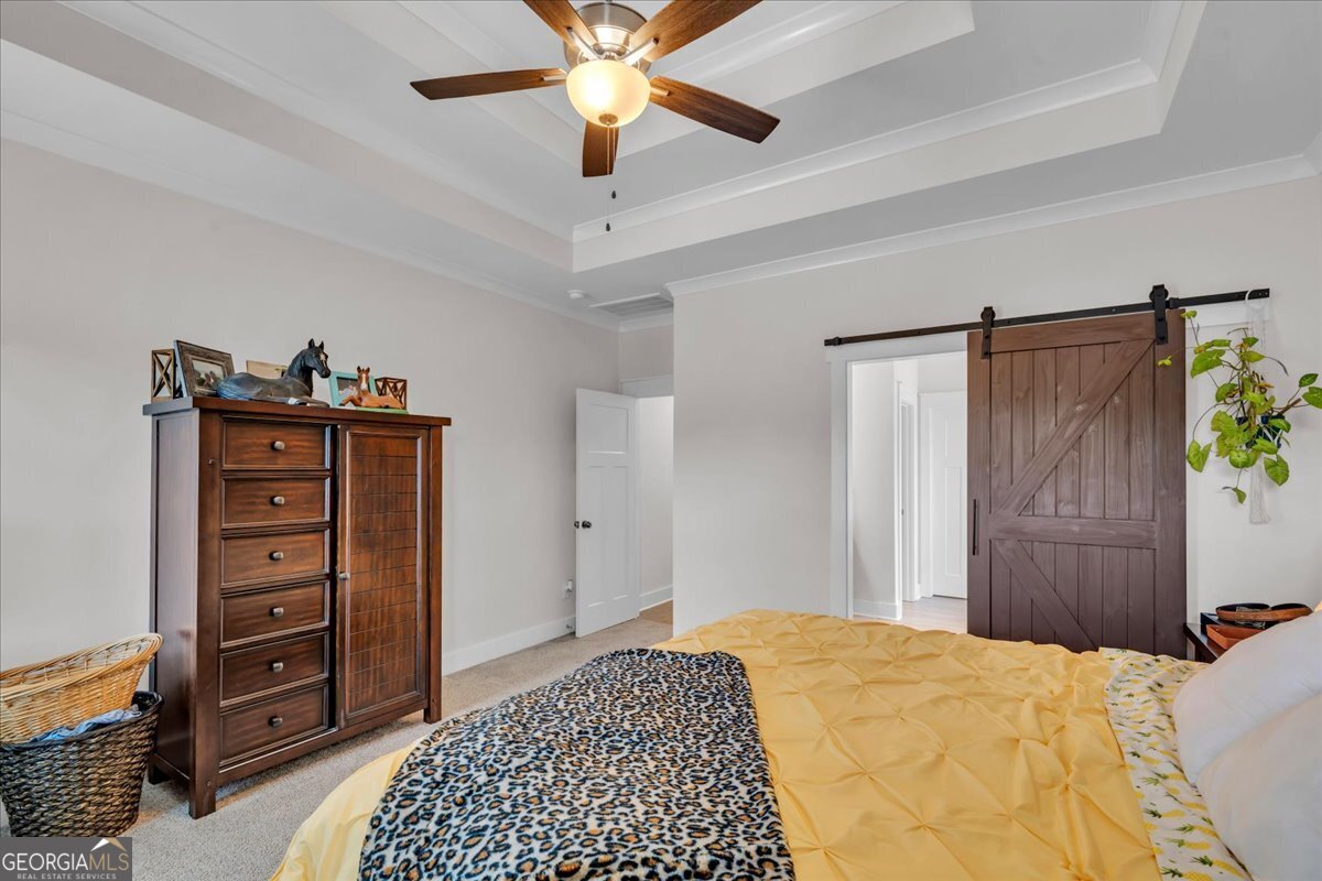 424 Rustic Live Oak Trail Bonaire, GA 31005 - Photo 21 of 51 a bedroom with a bed and a dresser