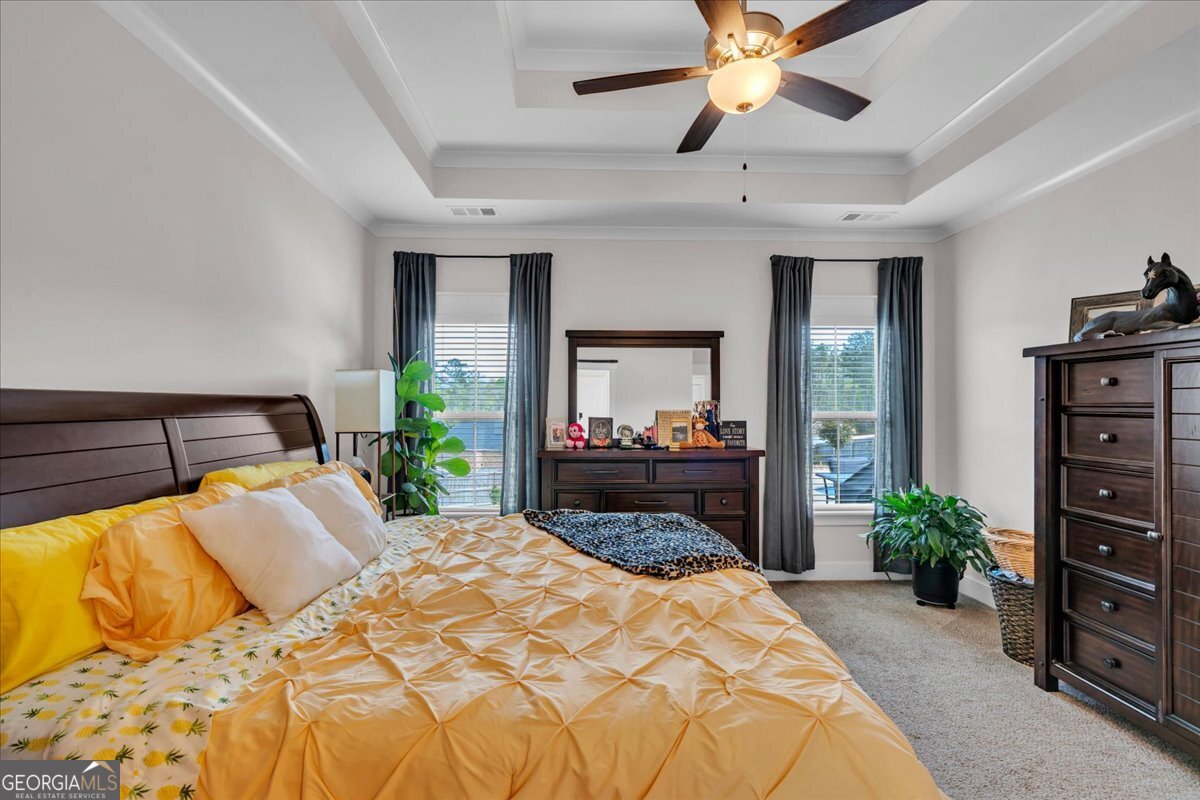 424 Rustic Live Oak Trail Bonaire, GA 31005 - Photo 22 of 51 a bedroom with a bed and a potted plant