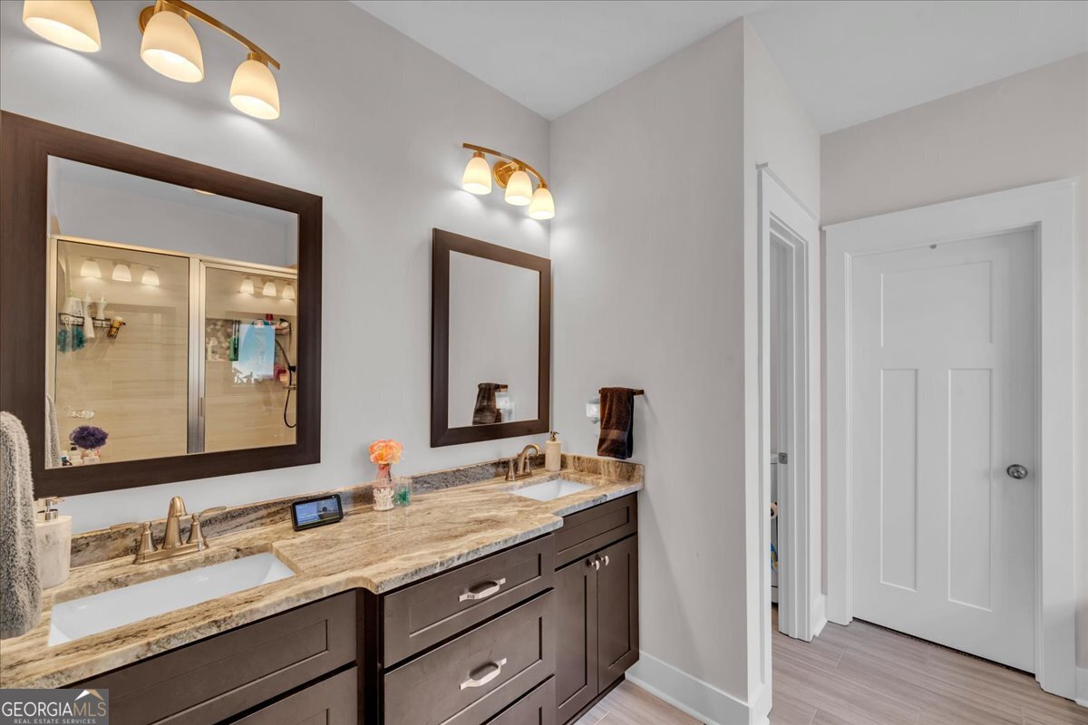 424 Rustic Live Oak Trail Bonaire, GA 31005 - Photo 24 of 51 a bathroom with a granite countertop double vanity sink and a mirror