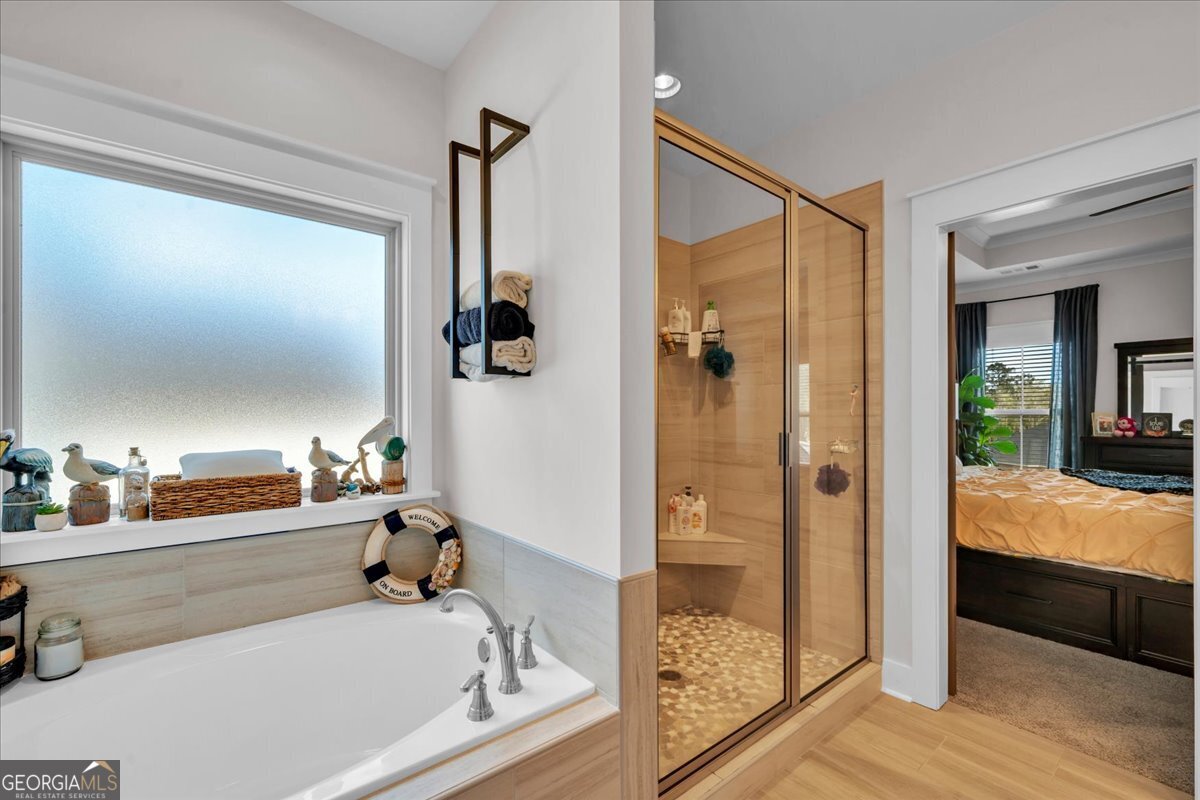 424 Rustic Live Oak Trail Bonaire, GA 31005 - Photo 25 of 51 a bathroom with a tub and a shower