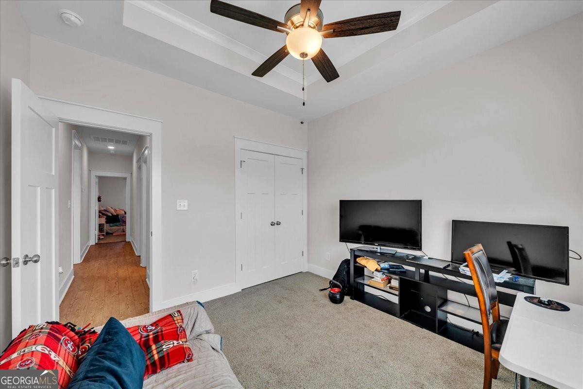 424 Rustic Live Oak Trail Bonaire, GA 31005 - Photo 28 of 51 a view of a livingroom with workspace and a flat screen tv
