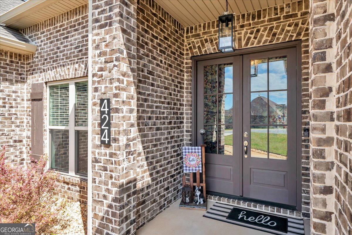 424 Rustic Live Oak Trail Bonaire, GA 31005 - Photo 3 of 51 a view of a brick wall with a window