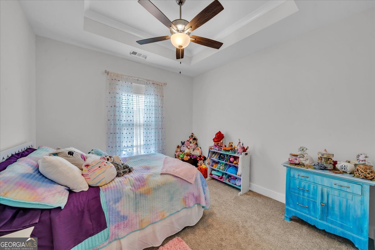 424 Rustic Live Oak Trail Bonaire, GA 31005 - Photo 32 of 51 a bedroom with a bed and a dresser in it