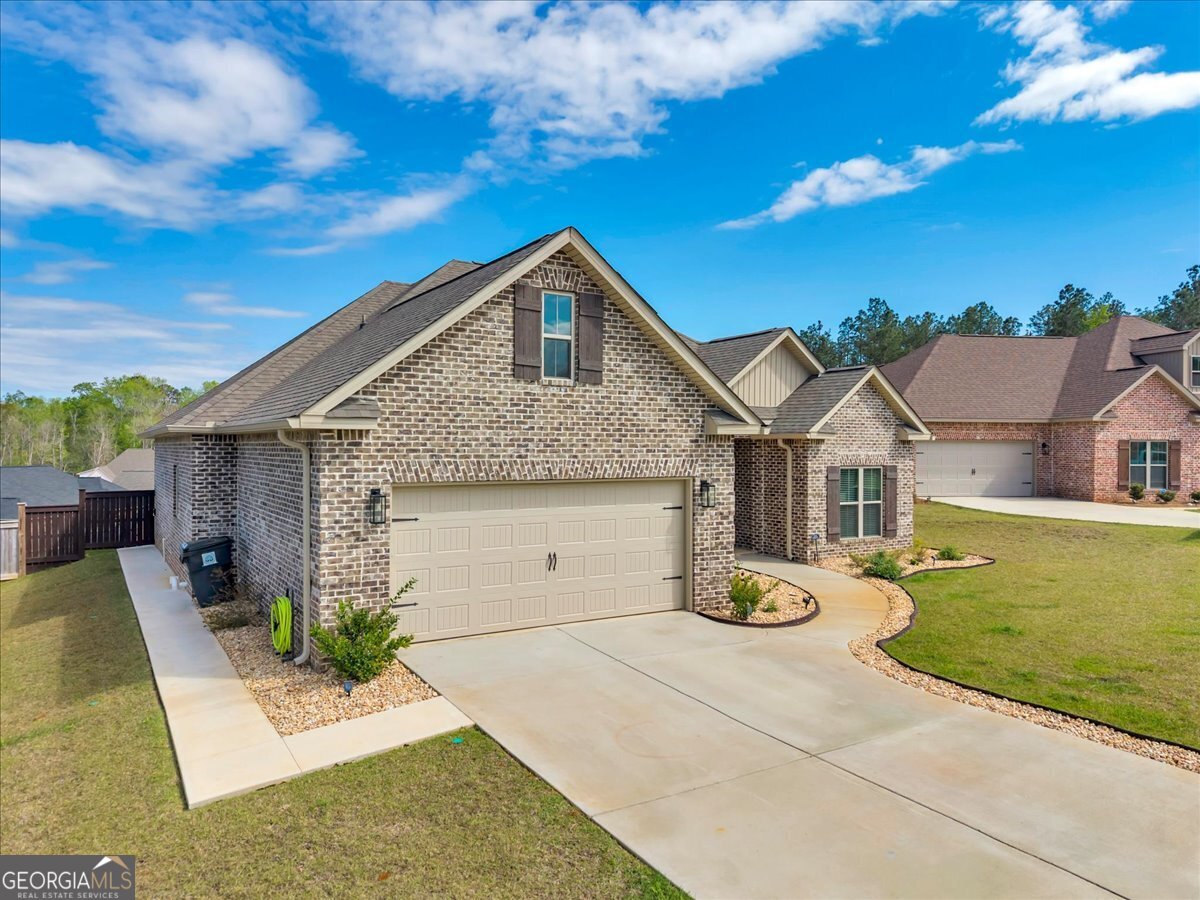 424 Rustic Live Oak Trail Bonaire, GA 31005 - Photo 43 of 51 a front view of a house with garden