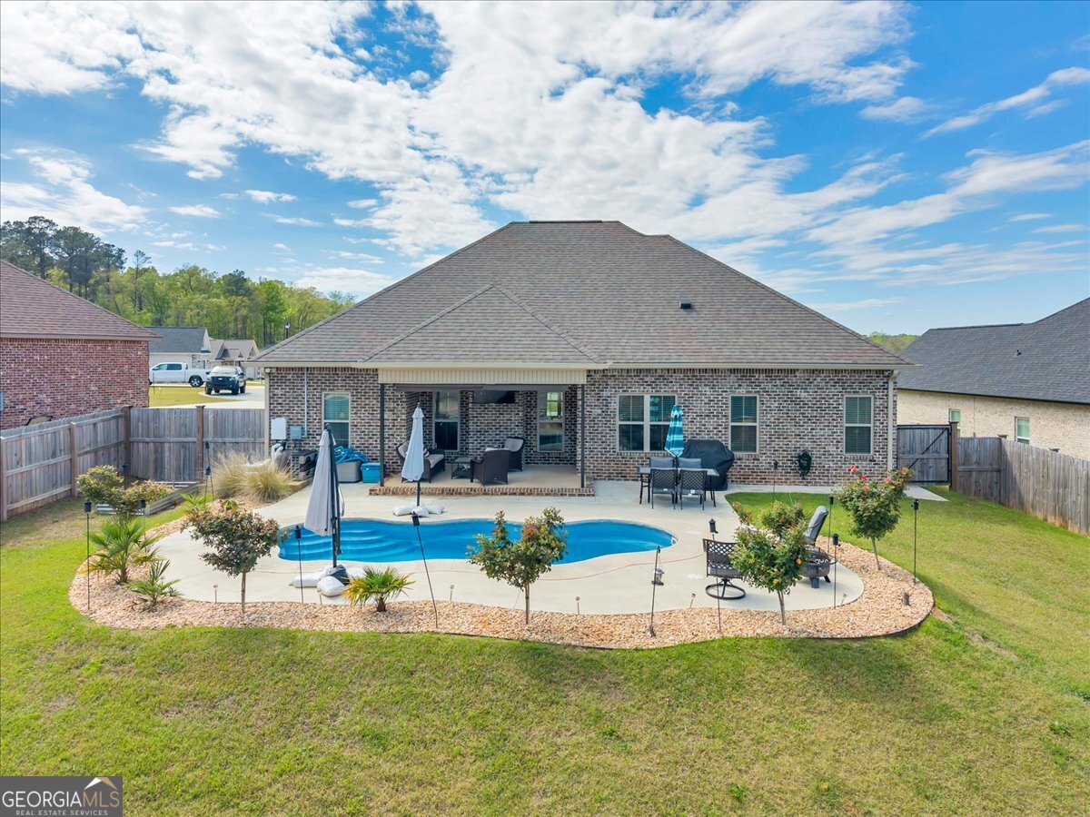 424 Rustic Live Oak Trail Bonaire, GA 31005 - Photo 46 of 51 a view of a house with a backyard porch and sitting area