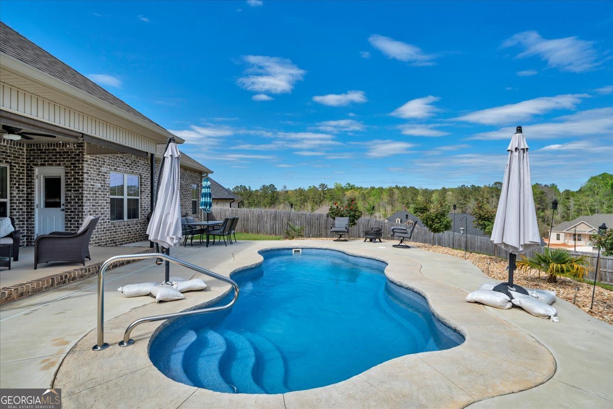 424 Rustic Live Oak Trail Bonaire, GA 31005 - Photo 48 of 51 a view of a swimming pool with lounge chair