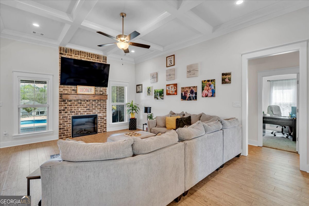 424 Rustic Live Oak Trail Bonaire, GA 31005 - Photo 5 of 51 a living room with furniture a flat screen tv and a fireplace