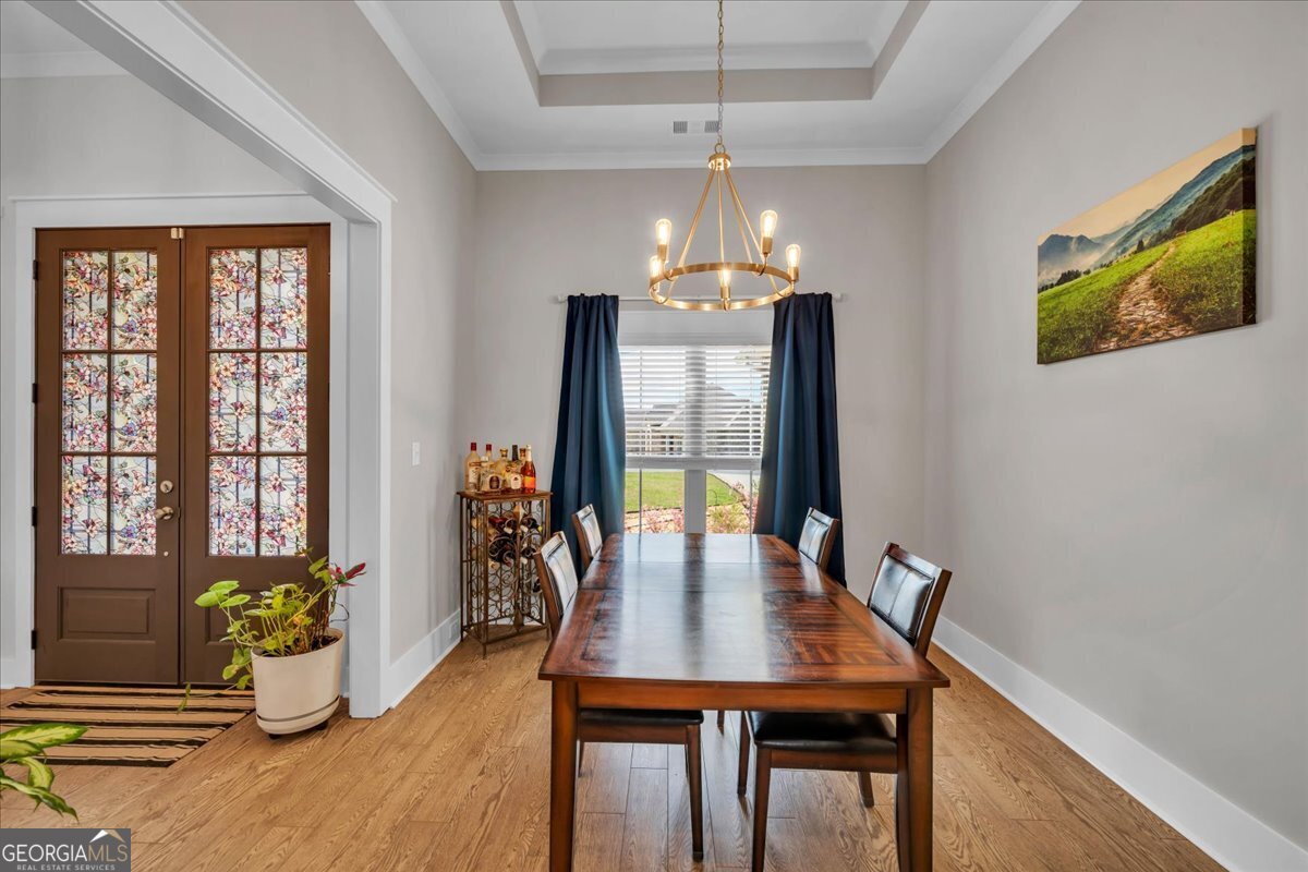 424 Rustic Live Oak Trail Bonaire, GA 31005 - Photo 7 of 51 a view of a dining room with furniture window and wooden floor