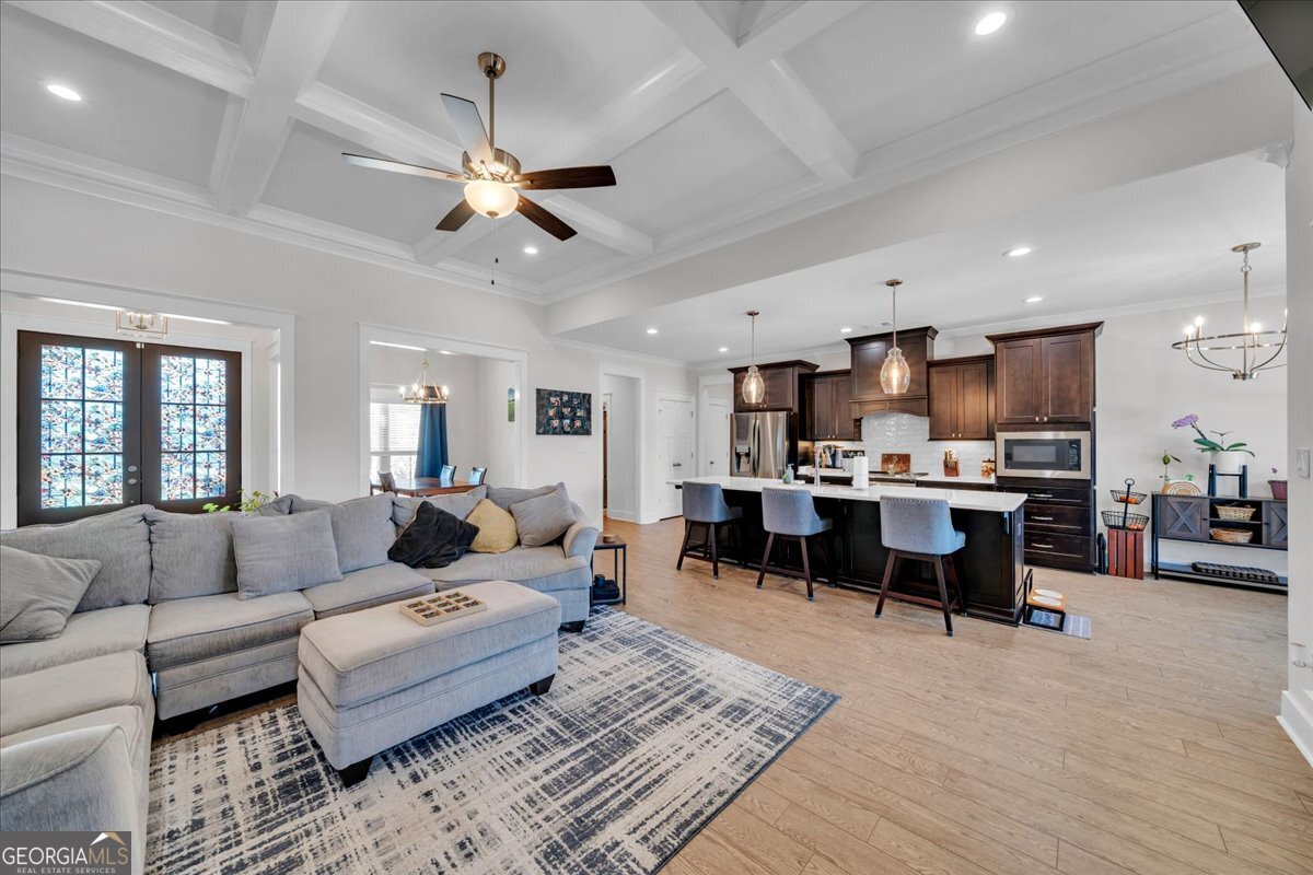 424 Rustic Live Oak Trail Bonaire, GA 31005 - Photo 9 of 51 a living room with furniture kitchen view and a chandelier